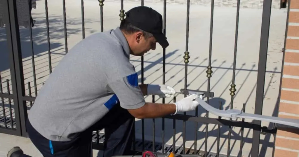 Technician installing an automatic gate opener.